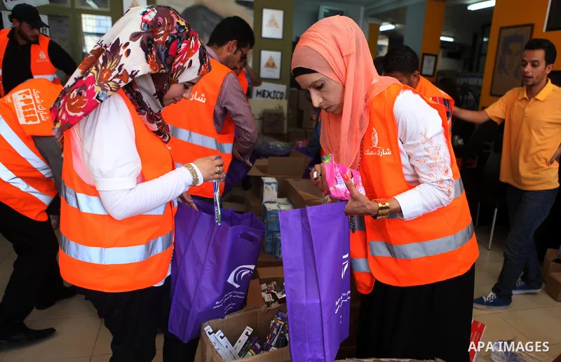 Palestinians collect human supplies to be sent to the stricken in the Gaza Strip in the West Bank city of Ramallah on August 28, 2014. Israel and Palestinians both boasted of victory in the Gaza war but analysts say Hama...