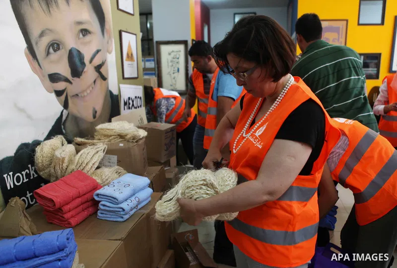 Palestinians collect human supplies to be sent to the stricken in the Gaza Strip in the West Bank city of Ramallah on August 28, 2014. Israel and Palestinians both boasted of victory in the Gaza war but analysts say Hama...