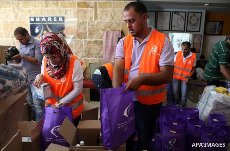 Palestinians collect human supplies to be sent to the stricken in the Gaza Strip in the West Bank city of Ramallah on August 28, 2014. Israel and Palestinians both boasted of victory in the Gaza war but analysts say Hama...