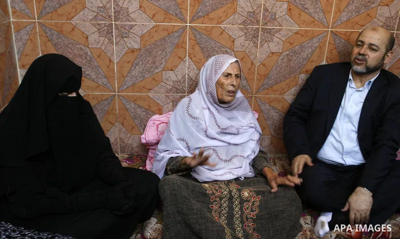 Senior Hamas official, Moussa Abu Marzouk visits the family of Raed Al-Attar in Rafah in southern Gaza strip on August 28, 2014. An open-ended ceasefire in the Gaza war held on Wednesday as Prime Minister Benjamin Netany...