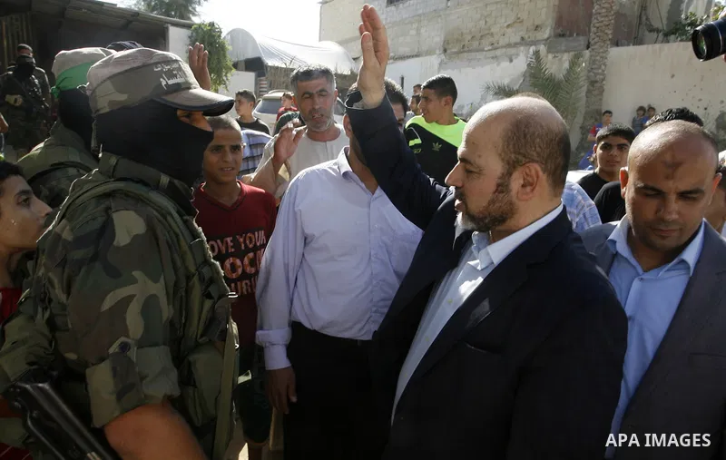 Hamas political leader Moussa Abu Marzouk visits the mourning tent of senior Hamas commander Mohammed Abu Shammala (seen in posters), who was killed by an Israeli air strike during the seven-week Israeli offensive, in Ra...