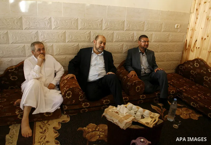 Hamas political leader Moussa Abu Marzouk visits the mourning tent of senior Hamas commander Mohammed Abu Shammala (seen in posters), who was killed by an Israeli air strike during the seven-week Israeli offensive, in Ra...