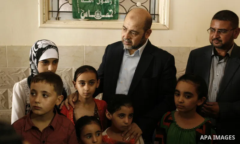 Hamas political leader Moussa Abu Marzouk visits the mourning tent of senior Hamas commander Mohammed Abu Shammala (seen in posters), who was killed by an Israeli air strike during the seven-week Israeli offensive, in Ra...