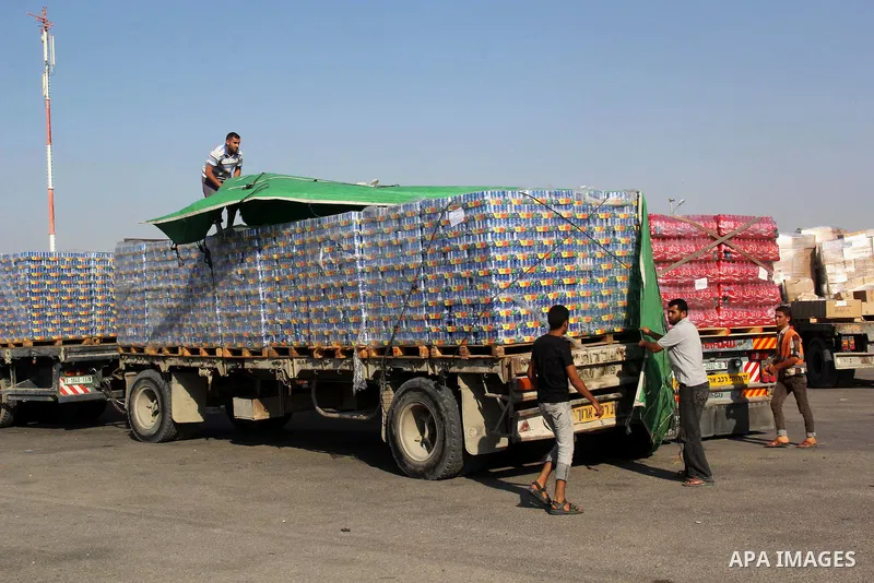 Palestinian men check a truck loaded with medical aid after entering Gaza at the Kerem Shalom crossing, in Rafah in the southern Gaza Strip August 28, 2014. An open-ended ceasefire in the Gaza war held on Wednesday as Pr...