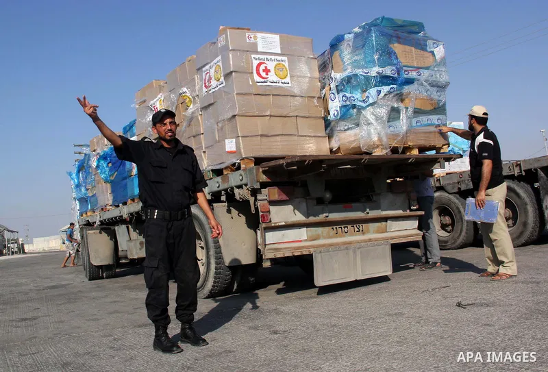 A member of the Palestinian security forces gestures as he stands next to a truck loaded with medical aid after entering Gaza at the Kerem Shalom crossing, in Rafah in the southern Gaza Strip August 28, 2014. An open-end...
