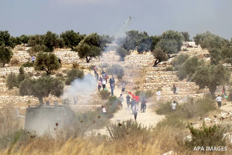 Palestinian protestors clash with Israeli security forces in the village of Bilin, near the West Bank city of Ramallah following a march in support of the resistance in the Gaza Strip on August 29, 2014. Seven weeks of w...