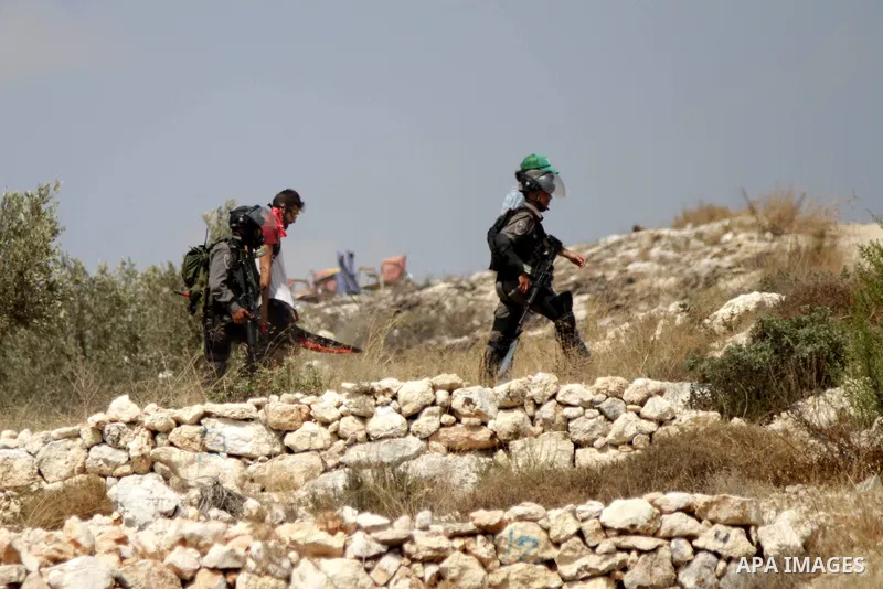 Members of the Israeli security forces arrest an Israeli demonstrating in solidarity with Palestinian protestors in the village of Bilin, near the West Bank city of Ramallah following a march in support of the resistance...