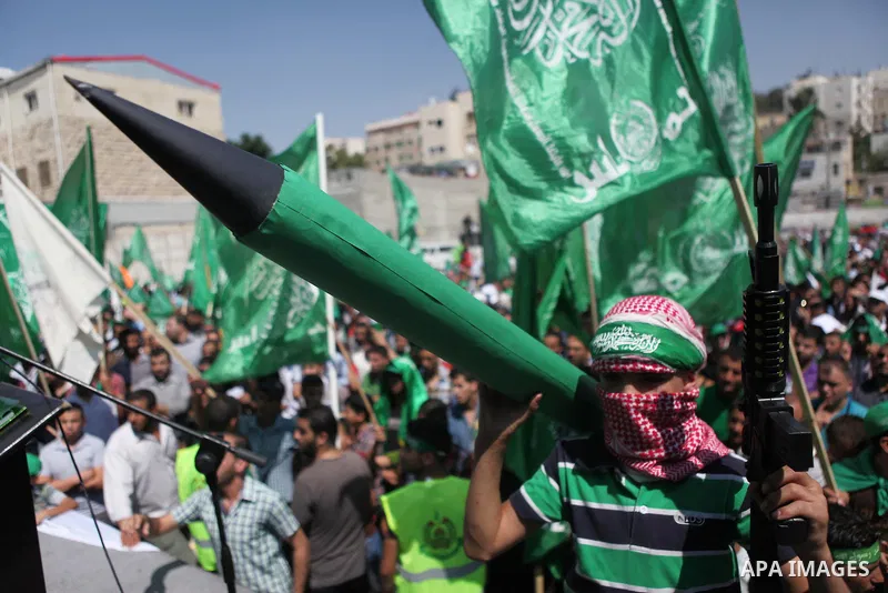 A masked Palestinian boy holds a mock rocket during a rally following the Friday prayers, three days after a deal hailed by Israel and Hamas as 'victory' in the 50-day war on August 29, 2014 in the West Bank town of Hebr...