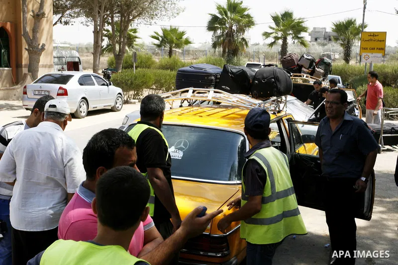 Palestinians wait to be given the permission to cross into Egypt at the Rafah border crossing in the southern Gaza Strip, on August 28, 2014. The Rafah crossing with Egypt is Gaza's only gateway to the world that is not...