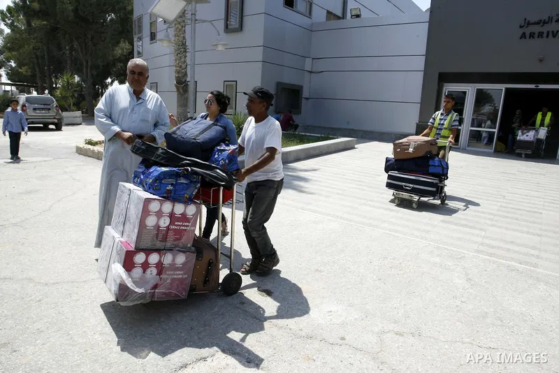 Palestinians wait to be given the permission to cross into Egypt at the Rafah border crossing in the southern Gaza Strip, on August 28, 2014. The Rafah crossing with Egypt is Gaza's only gateway to the world that is not...