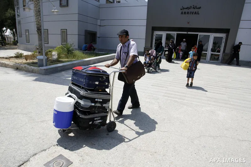 Palestinians wait to be given the permission to cross into Egypt at the Rafah border crossing in the southern Gaza Strip, on August 28, 2014. The Rafah crossing with Egypt is Gaza's only gateway to the world that is not...