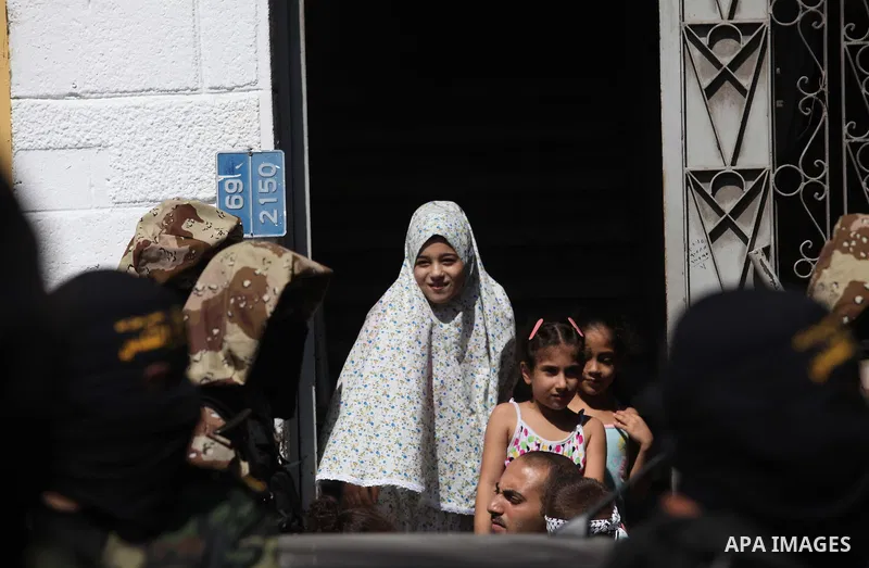 Palestinians take part in a rally celebrating what they say was a victory over Israel following a ceasefire in Gaza City August 29, 2014. An open-ended ceasefire, mediated by Egypt, took effect on Tuesday evening. It cal...