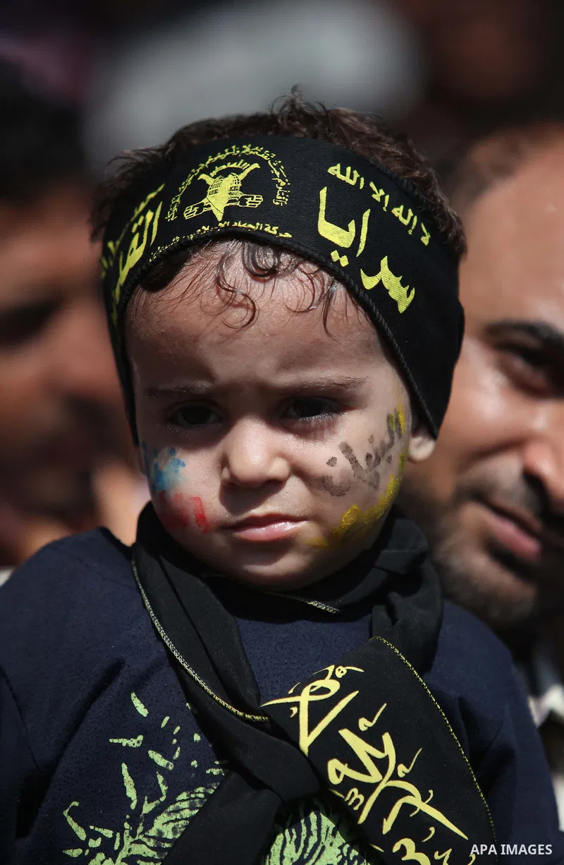 A Palestinian boy takes part in a rally celebrating what they say was a victory over Israel following a ceasefire in Gaza City August 29, 2014. An open-ended ceasefire, mediated by Egypt, took effect on Tuesday evening....