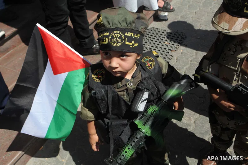A Palestinian boy holds a replica gun as Palestinians in a rally celebrating what they say was a victory over Israel following a ceasefire in Gaza City August 29, 2014. An open-ended ceasefire, mediated by Egypt, took ef...