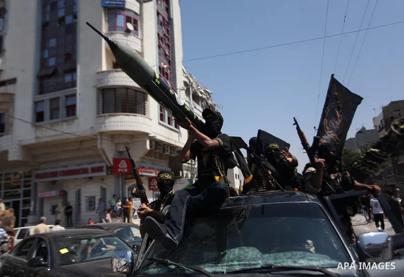 Palestinian Islamic Jihad supporters celebrate with people what they said was a victory over Israel, in Gaza City August 29, 2014. An open-ended ceasefire, mediated by Egypt, took effect on Tuesday evening. It called for...