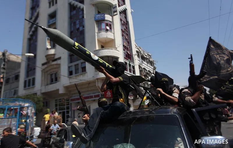 Palestinian Islamic Jihad supporters celebrate with people what they said was a victory over Israel, in Gaza City August 29, 2014. An open-ended ceasefire, mediated by Egypt, took effect on Tuesday evening. It called for...