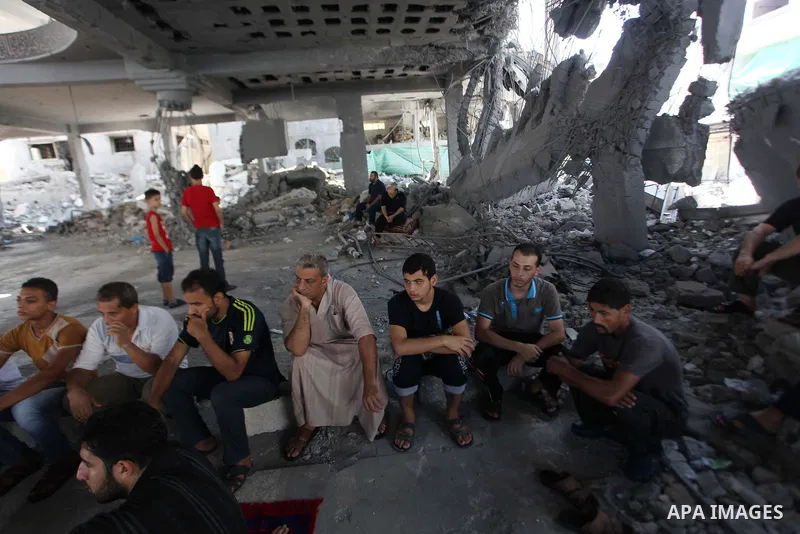 Palestinians perform Friday prayers at the remains of a mosque, which witnesses said was hit by an Israeli air strike during a seven-week Israeli offensive in Gaza City August 29, 2014. An open-ended ceasefire, mediated...
