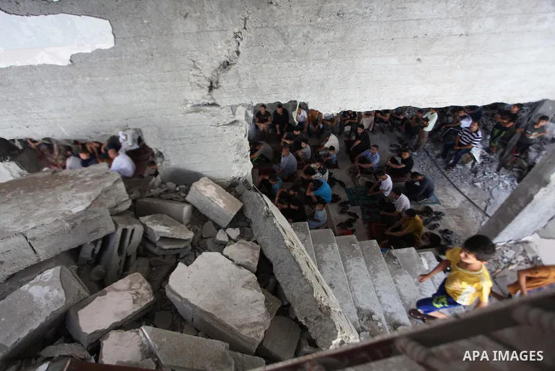 Palestinians perform Friday prayers at the remains of a mosque, which witnesses said was hit by an Israeli air strike during a seven-week Israeli offensive in Gaza City August 29, 2014. An open-ended ceasefire, mediated...