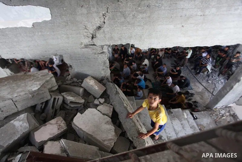 Palestinians perform Friday prayers at the remains of a mosque, which witnesses said was hit by an Israeli air strike during a seven-week Israeli offensive in Gaza City August 29, 2014. An open-ended ceasefire, mediated...