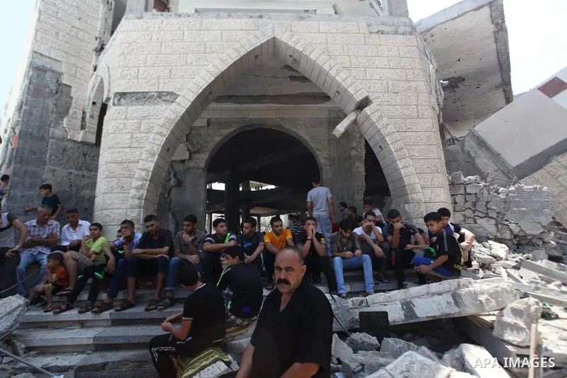Palestinians perform Friday prayers at the remains of a mosque, which witnesses said was hit by an Israeli air strike during a seven-week Israeli offensive in Gaza City August 29, 2014. An open-ended ceasefire, mediated...