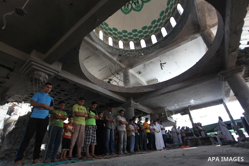 Palestinians perform Friday prayers at the remains of a mosque, which witnesses said was hit by an Israeli air strike during a seven-week Israeli offensive in Gaza City August 29, 2014. An open-ended ceasefire, mediated...