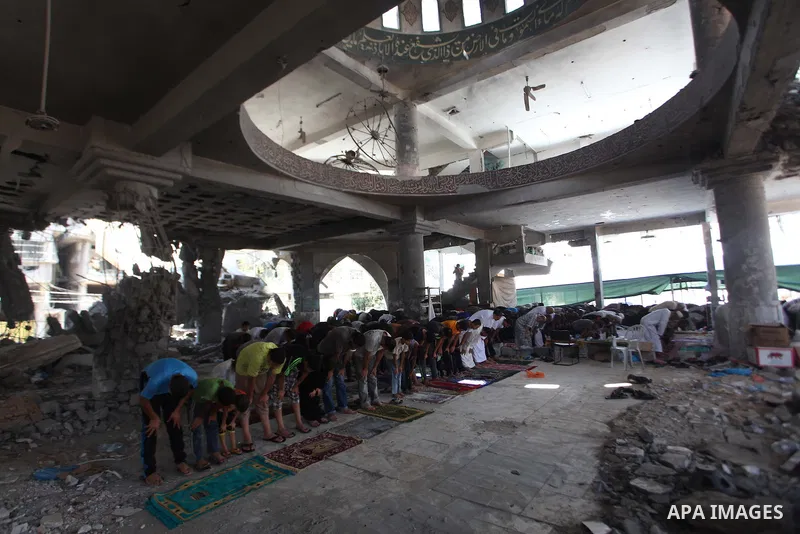 Palestinians perform Friday prayers at the remains of a mosque, which witnesses said was hit by an Israeli air strike during a seven-week Israeli offensive in Gaza City August 29, 2014. An open-ended ceasefire, mediated...