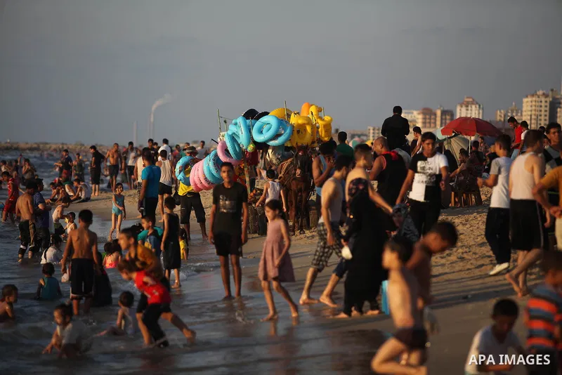 Palestinians swim in the Mediterranean Sea off the coast of Gaza City August 29, 2014, days after a ceasefire was reached. An open-ended ceasefire, mediated by Egypt, took effect on Tuesday evening. It called for an inde...