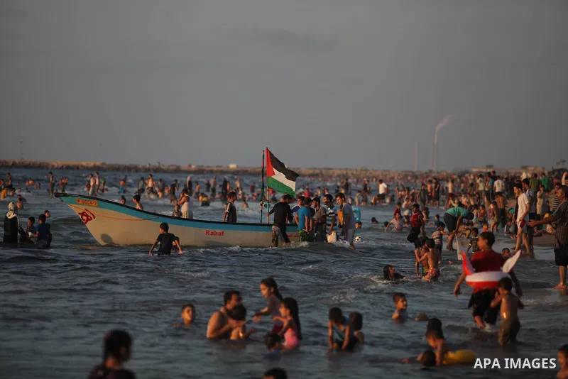 Palestinians swim in the Mediterranean Sea off the coast of Gaza City August 29, 2014, days after a ceasefire was reached. An open-ended ceasefire, mediated by Egypt, took effect on Tuesday evening. It called for an inde...