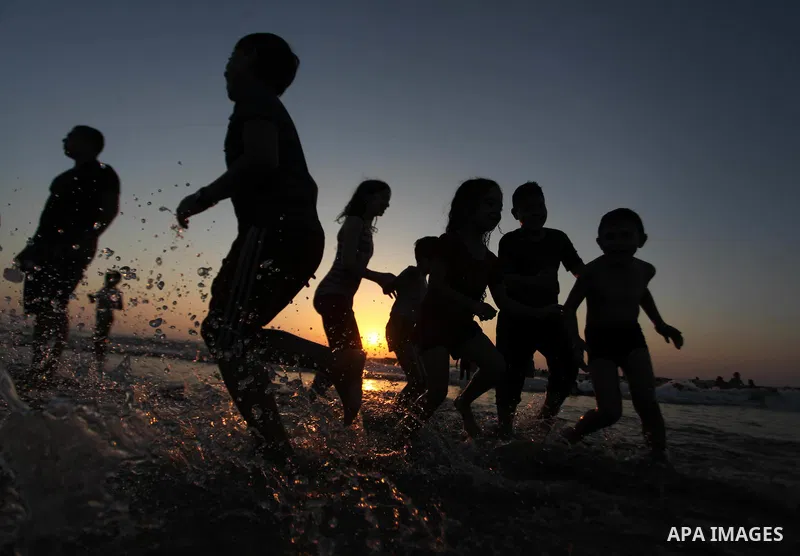 Palestinians play in the Mediterranean Sea off the coast of Gaza City August 29, 2014, days after a ceasefire was reached. An open-ended ceasefire, mediated by Egypt, took effect on Tuesday evening. It called for an inde...