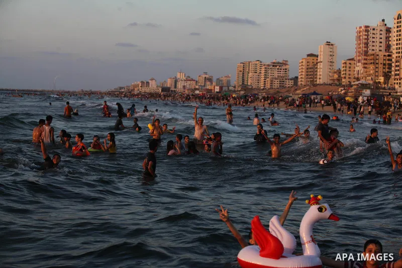 Palestinians swim in the Mediterranean Sea off the coast of Gaza City August 29, 2014, days after a ceasefire was reached. An open-ended ceasefire, mediated by Egypt, took effect on Tuesday evening. It called for an inde...