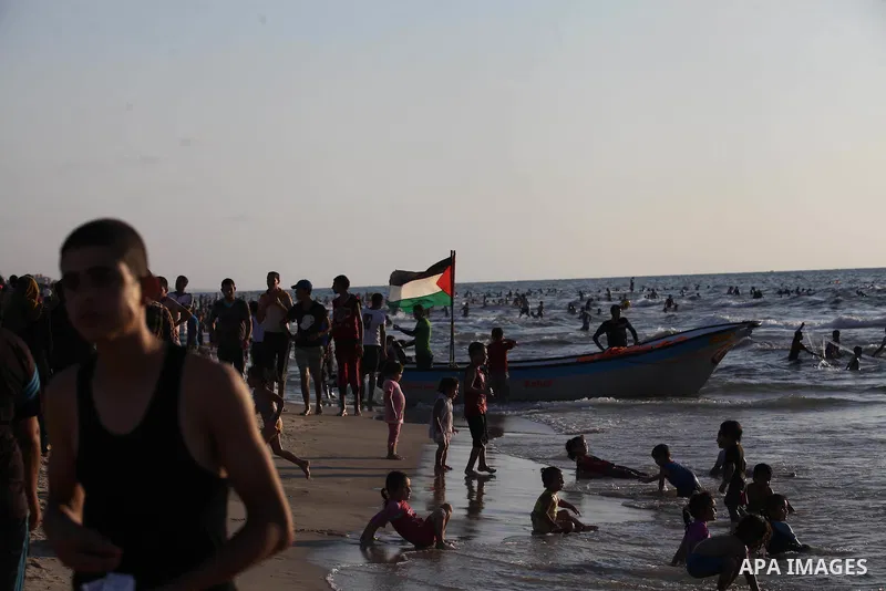 Palestinians swim in the Mediterranean Sea off the coast of Gaza City August 29, 2014, days after a ceasefire was reached. An open-ended ceasefire, mediated by Egypt, took effect on Tuesday evening. It called for an inde...