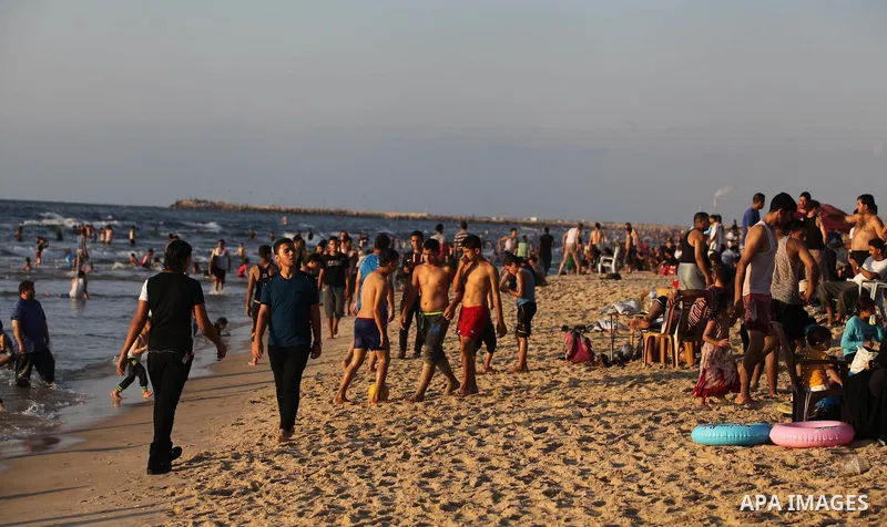 Palestinians swim in the Mediterranean Sea off the coast of Gaza City August 29, 2014, days after a ceasefire was reached. An open-ended ceasefire, mediated by Egypt, took effect on Tuesday evening. It called for an inde...