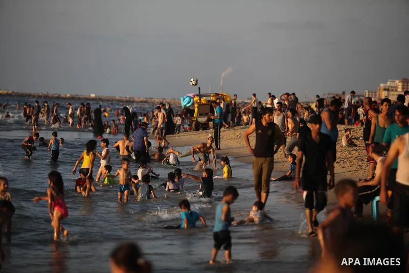 Palestinians swim in the Mediterranean Sea off the coast of Gaza City August 29, 2014, days after a ceasefire was reached. An open-ended ceasefire, mediated by Egypt, took effect on Tuesday evening. It called for an inde...