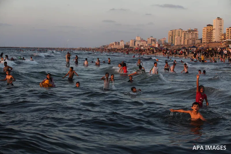 Palestinians swim in the Mediterranean Sea off the coast of Gaza City August 29, 2014, days after a ceasefire was reached. An open-ended ceasefire, mediated by Egypt, took effect on Tuesday evening. It called for an inde...