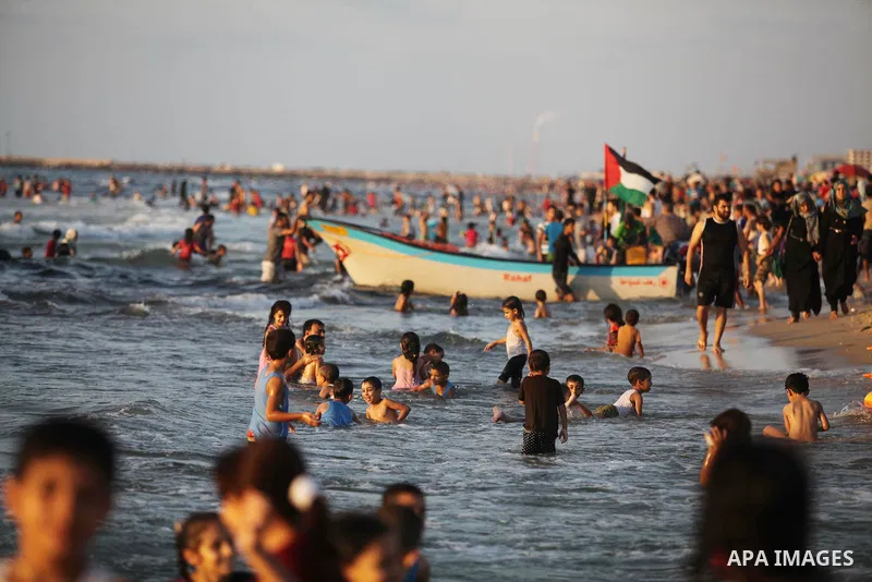 Palestinians swim in the Mediterranean Sea off the coast of Gaza City August 29, 2014, days after a ceasefire was reached. An open-ended ceasefire, mediated by Egypt, took effect on Tuesday evening. It called for an inde...