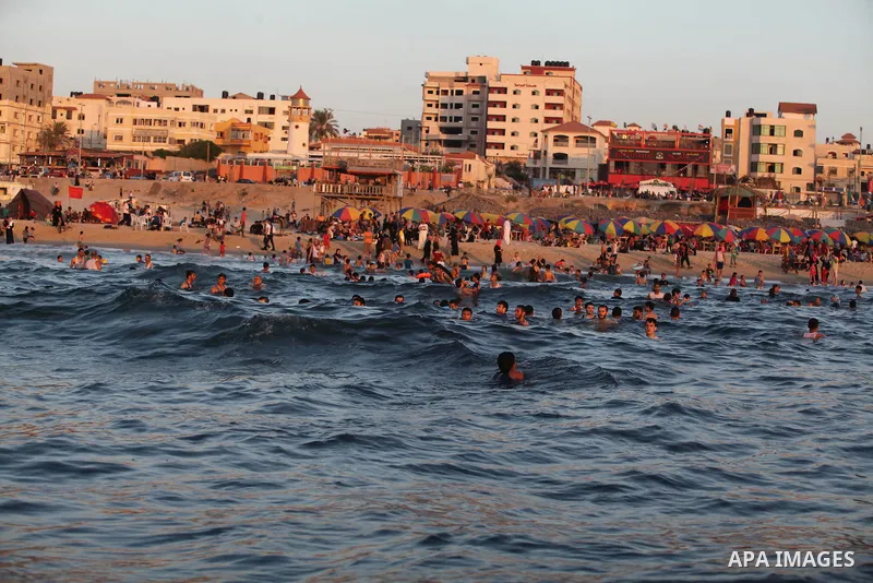 Palestinians swim in the Mediterranean Sea off the coast of Gaza City August 29, 2014, days after a ceasefire was reached. An open-ended ceasefire, mediated by Egypt, took effect on Tuesday evening. It called for an inde...