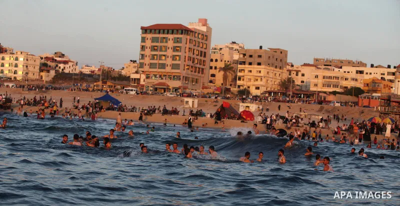 Palestinians swim in the Mediterranean Sea off the coast of Gaza City August 29, 2014, days after a ceasefire was reached. An open-ended ceasefire, mediated by Egypt, took effect on Tuesday evening. It called for an inde...