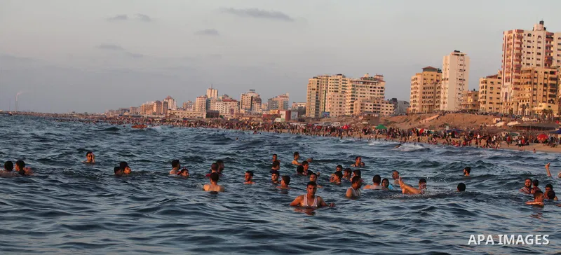 Palestinians swim in the Mediterranean Sea off the coast of Gaza City August 29, 2014, days after a ceasefire was reached. An open-ended ceasefire, mediated by Egypt, took effect on Tuesday evening. It called for an inde...
