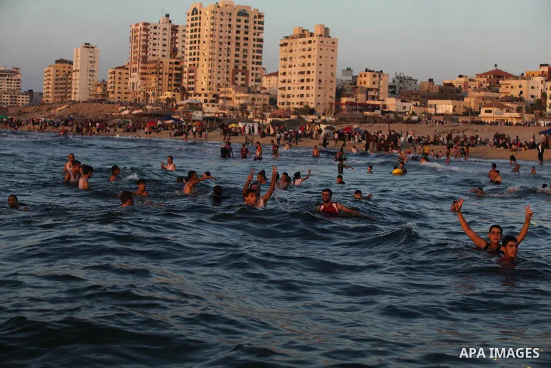 Palestinians play in the Mediterranean Sea off the coast of Gaza City August 29, 2014, days after a ceasefire was reached. An open-ended ceasefire, mediated by Egypt, took effect on Tuesday evening. It called for an inde...