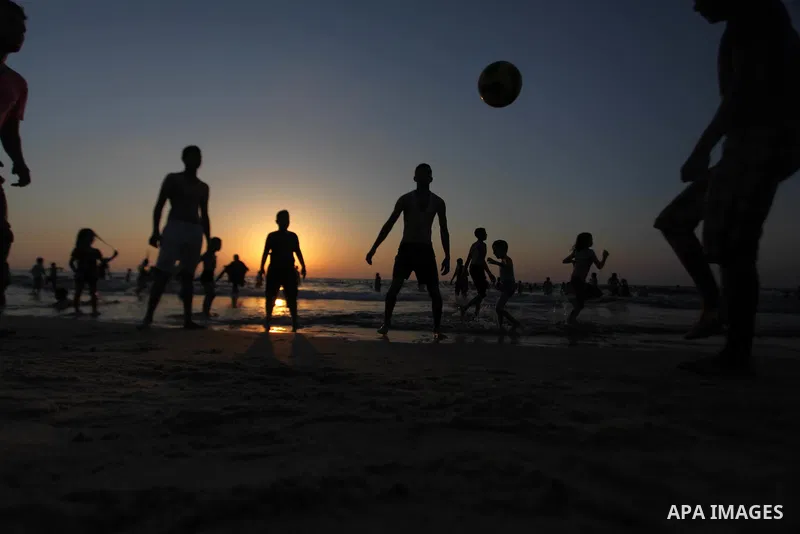 Palestinians play in the Mediterranean Sea off the coast of Gaza City August 29, 2014, days after a ceasefire was reached. An open-ended ceasefire, mediated by Egypt, took effect on Tuesday evening. It called for an inde...