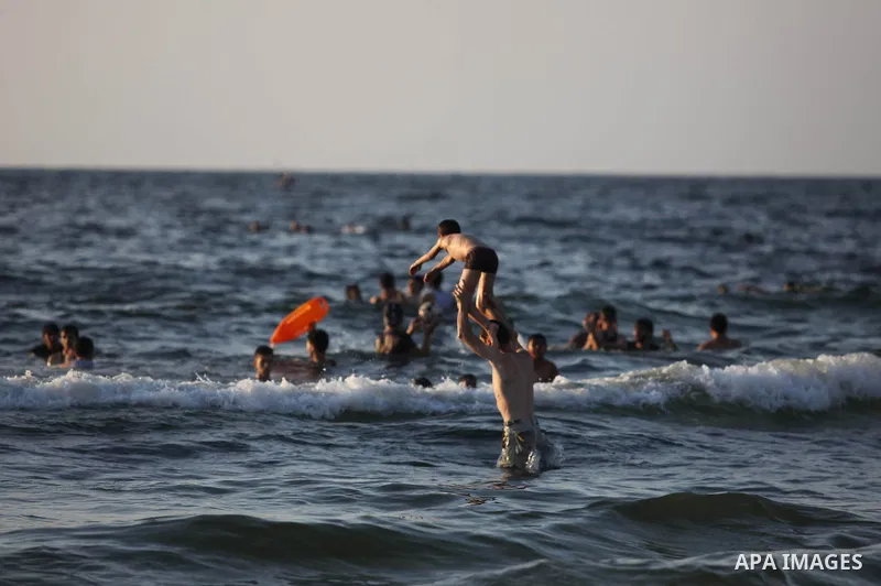 Palestinians swim in the Mediterranean Sea off the coast of Gaza City August 29, 2014, days after a ceasefire was reached. An open-ended ceasefire, mediated by Egypt, took effect on Tuesday evening. It called for an inde...