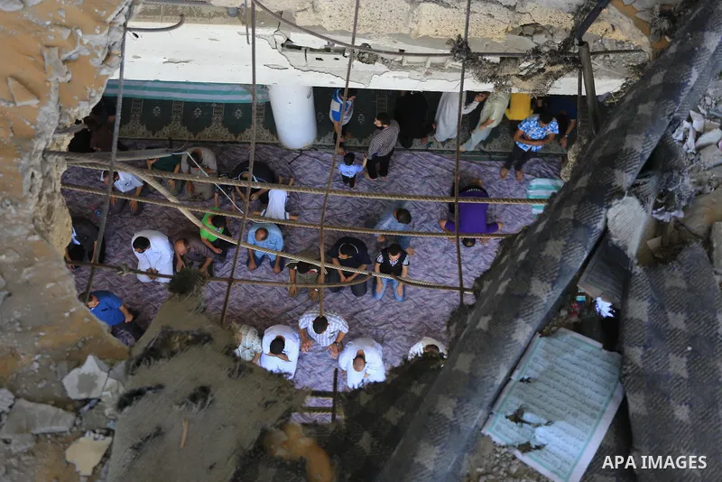 Palestinians perform Friday prayers at the remains of a mosque, which witnesses said was hit by an Israeli air strike during a seven-week Israeli offensive in Gaza City August 29, 2014. An open-ended ceasefire, mediated...