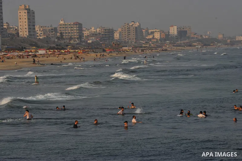 Palestinians swim in the Mediterranean Sea off the coast of Gaza City on August 29, 2014. Israel and Hamas accepted an Egyptian proposal for a long-term ceasefire in war-torn Gaza on August 26 in a move to end 50 days of...