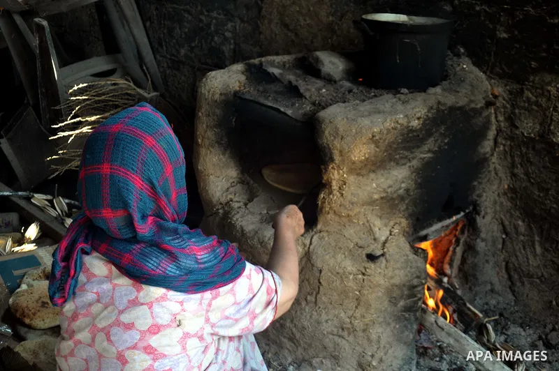Palestinian women bake bread on the rubble of their house which witnesses said was destroyed during the Israeli offensive in Shejaiya neighborhood after a ceasefire was declared, in Gaza city on August 30, 2014. An open-...
