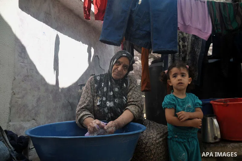 A Palestinian woman washes clothes on the rubble of their house which witnesses said was destroyed during the Israeli offensive in Shejaiya neighborhood after a ceasefire was declared, in Gaza city on August 30, 2014. An...