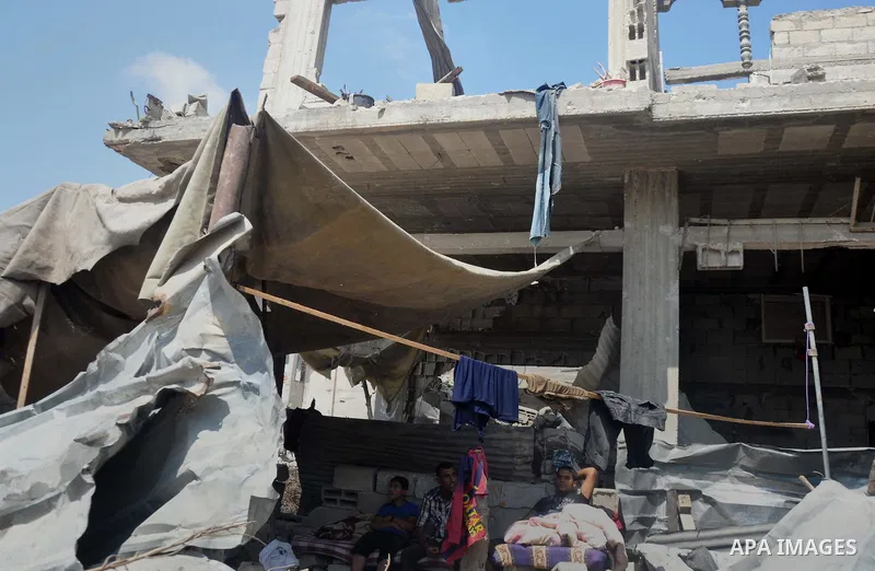 Palestinians sit at a tent on the rubble of their house which witnesses said was destroyed during the Israeli offensive in Shejaiya neighborhood after a ceasefire was declared, in Gaza city on August 30, 2014. An open-en...