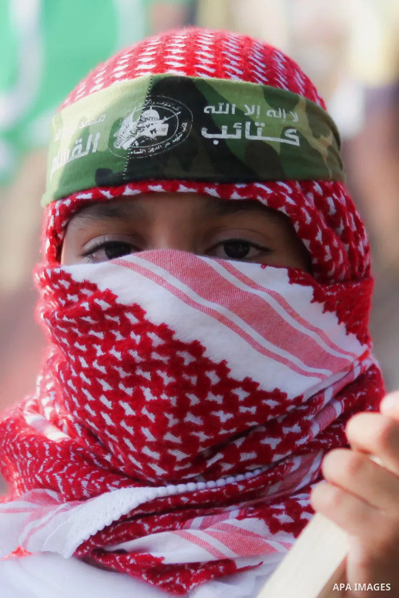 A masked Palestinian boy takes part during a celebrate in a victory by Palestinians in Gaza over Israel following a ceasefire, in the West Bank city of Ramallah August 30, 2014. An open-ended ceasefire, mediated by Egypt...
