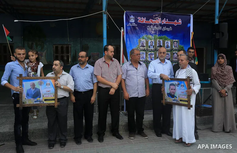 Palestinian Journalists's families take part in a ceremony honoring in Gaza city on 30 August 2014. An indefinite ceasefire to end seven weeks of fighting between Israel and Palestinian militant groups in the Gaza Strip...