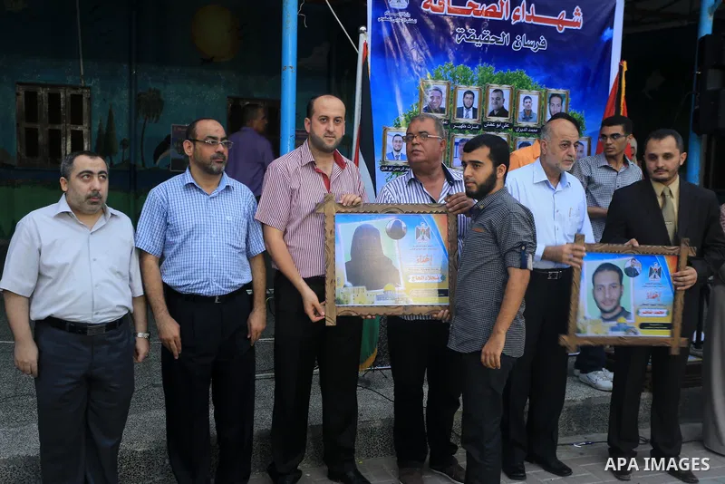 Palestinian Journalists's families take part in a ceremony honoring in Gaza city on 30 August 2014. An indefinite ceasefire to end seven weeks of fighting between Israel and Palestinian militant groups in the Gaza Strip...