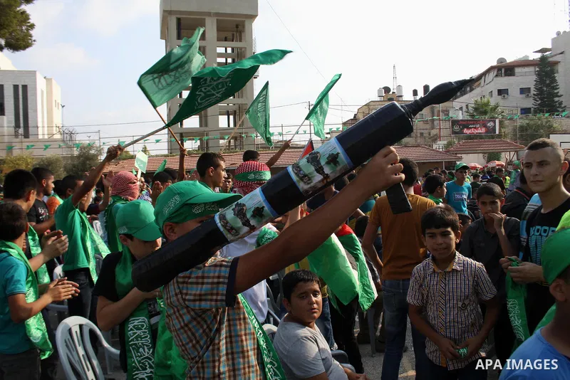 A Palestinian boy holds a mock rocket during a rally showing their support and solidarity with Hamas in the West Bank city of Tulkarem, 30 August 2014. An indefinite ceasefire to end seven weeks of fighting between Israe...